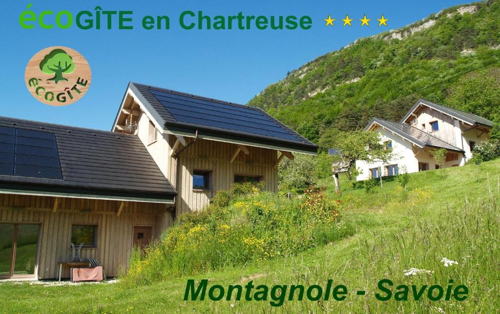 a house with solar panels on the side of it at La Grange aux écureuils in Montagnole