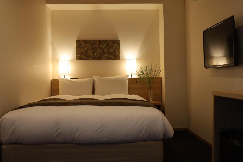 Postel nebo postele na pokoji v ubytování Xcellent Hotel