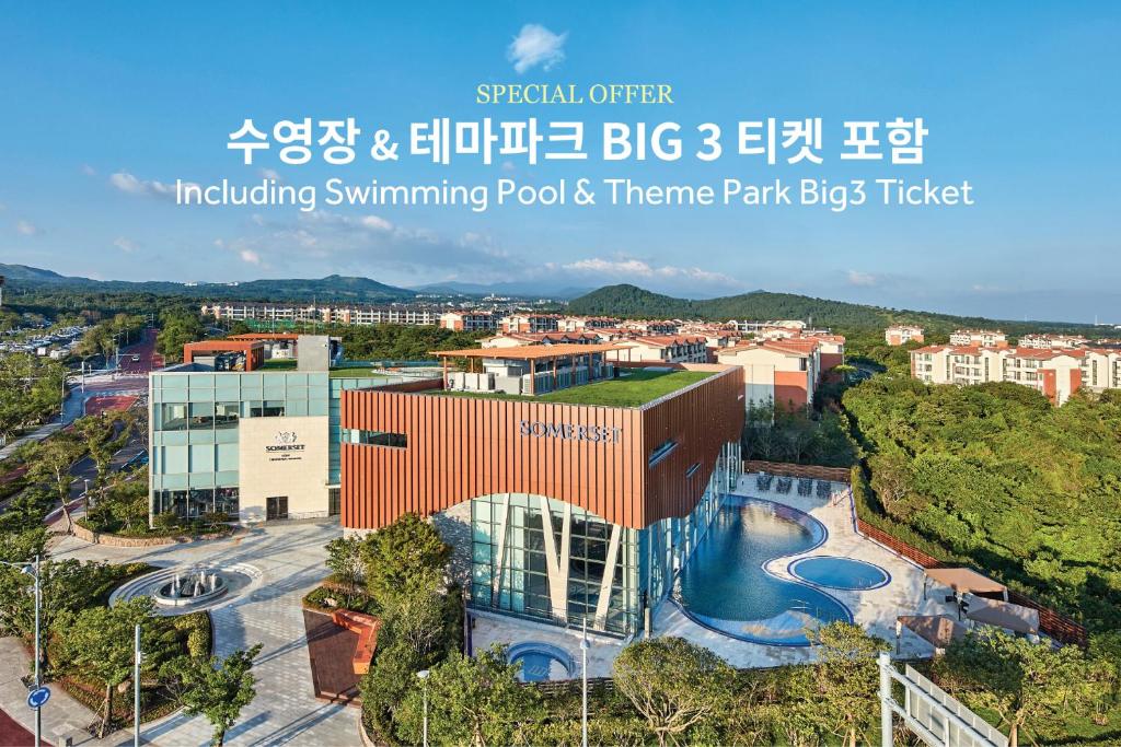 een gebouw met een zwembad en een stad bij Somerset Jeju Shinhwa World in Seogwipo