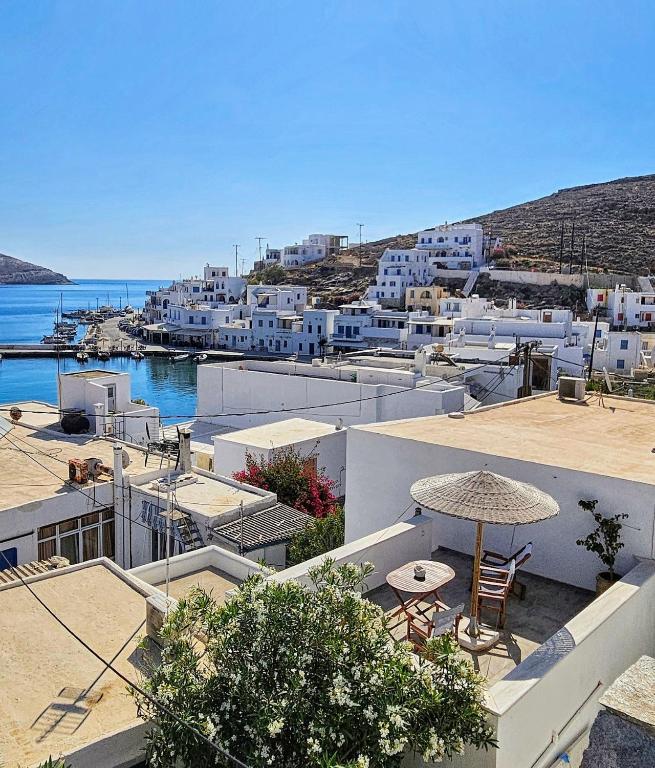 a view of a town with white buildings and the ocean at Sea-View Rooftop Terrace Studio in Panormos