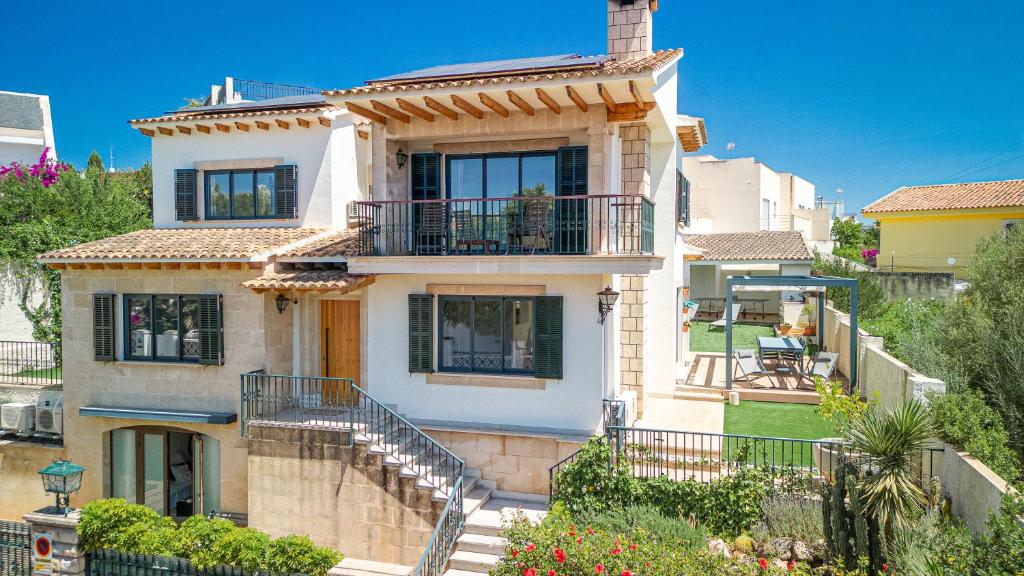 a large white house with stairs leading up to it at Villa Ca'n Alonso - Families & Athletes Only in Palma de Mallorca