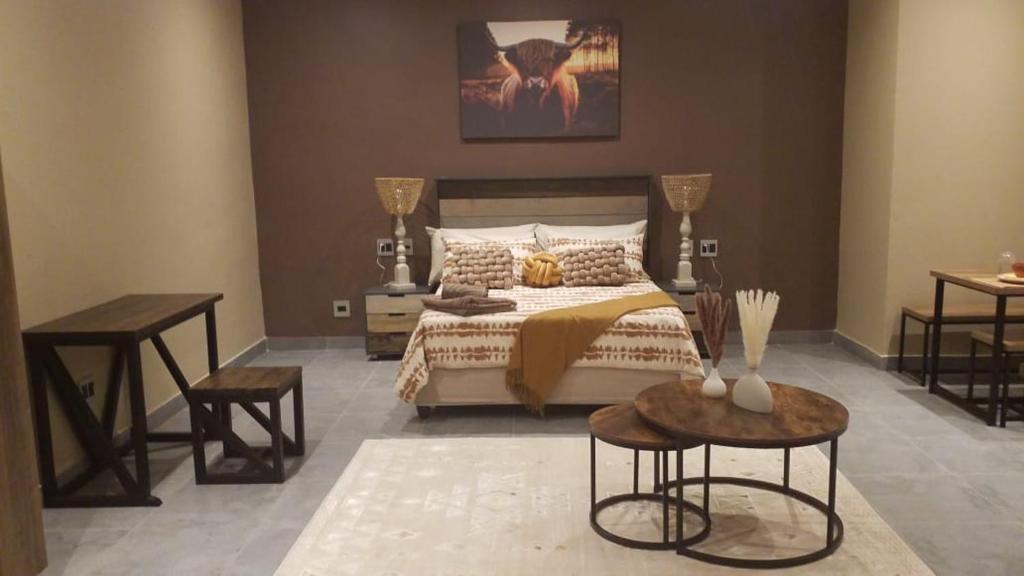 a bedroom with a bed with two tables and two tables sidx sidx sidx at South Gate Country Lodge in Polokwane