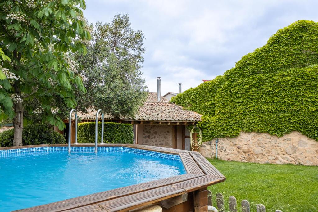 a swimming pool in the yard of a house at La Casona y Casitas de Tabladillo in Santa María la Real de Nieva