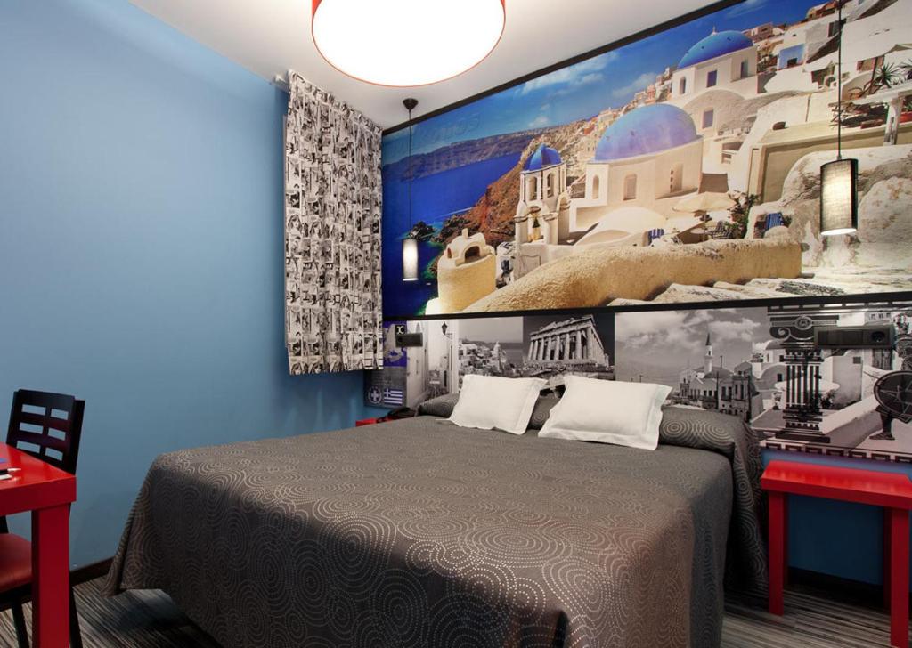 a bedroom with a bed with a large painting on the wall at JC Rooms Santo Domingo in Madrid