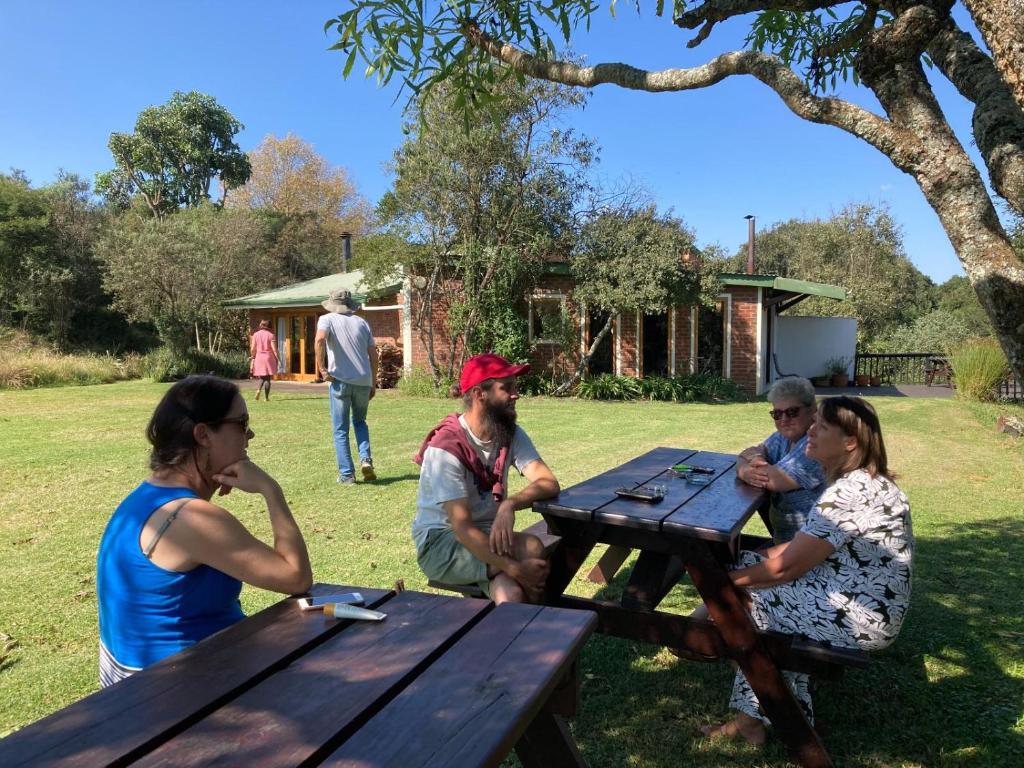 a group of people sitting at a picnic table at Midlands Forest Lodge in Balgowan