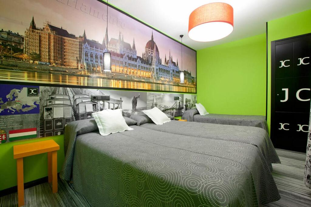a bedroom with a bed and a painting on the wall at JC Rooms Santo Domingo in Madrid