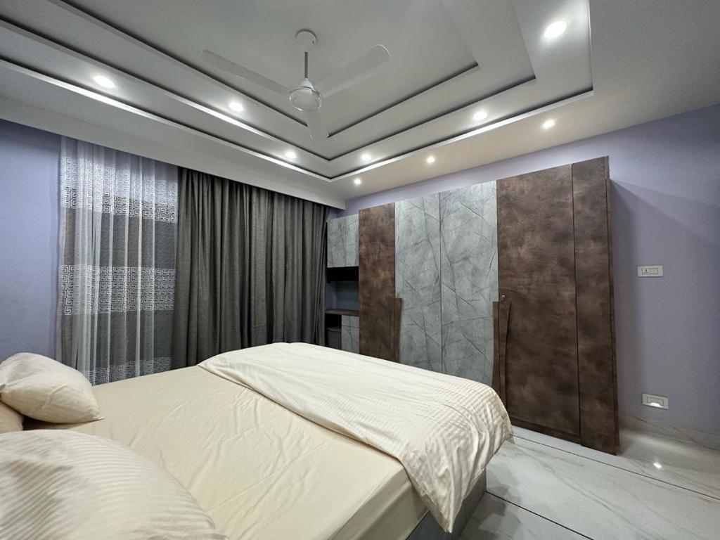 a bedroom with a large bed and a window at TAJ ELEGANCE Luxury Service Apartment in Bhatkal