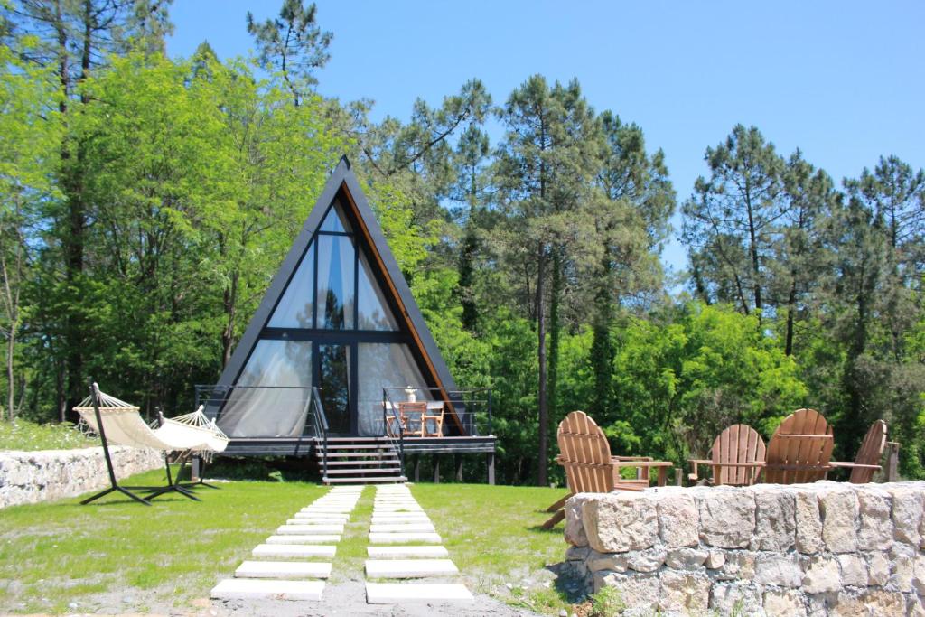a dome tent with chairs and a table in the grass at Vintage Cabin in Kutaisi