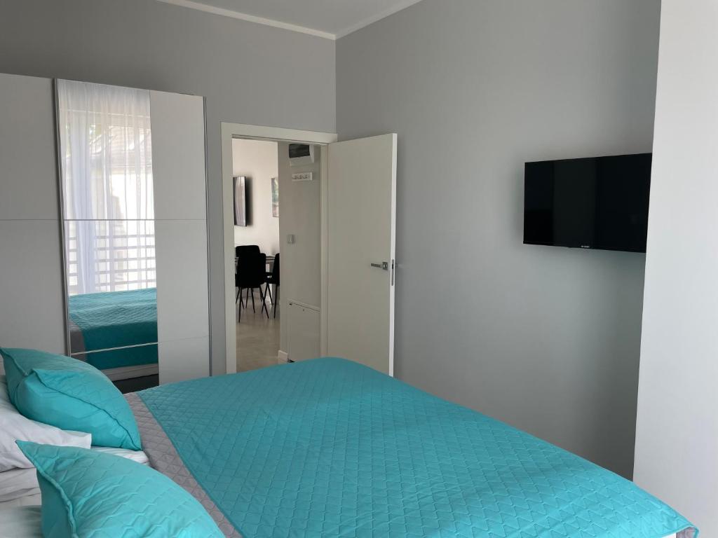 Televízia a/alebo spoločenská miestnosť v ubytovaní Apartamenty AQUA MAZURY