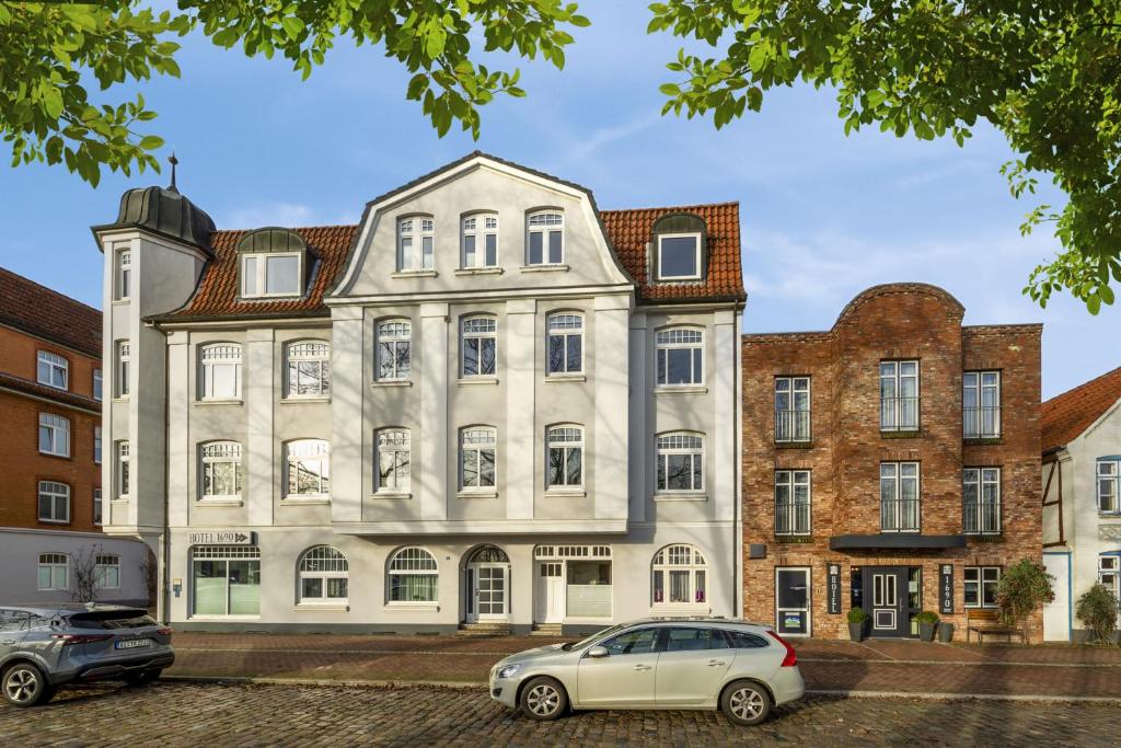 a white car parked in front of a building at Designhotel 1690 & Apartments in Rendsburg