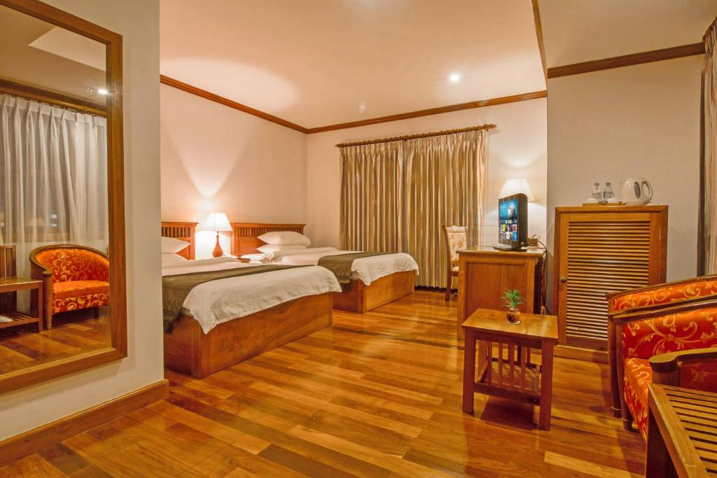 Postel nebo postele na pokoji v ubytování Cheathata CTA Hotel Siem Reap