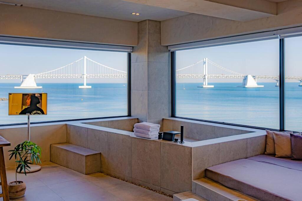 a bathroom with a view of the golden gate bridge at Paradise on earth in Busan