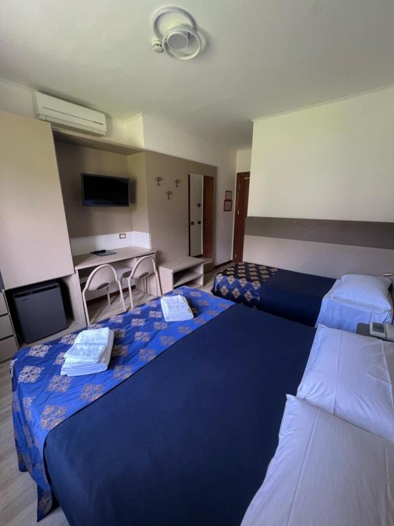 Postel nebo postele na pokoji v ubytování Hotel Merloni