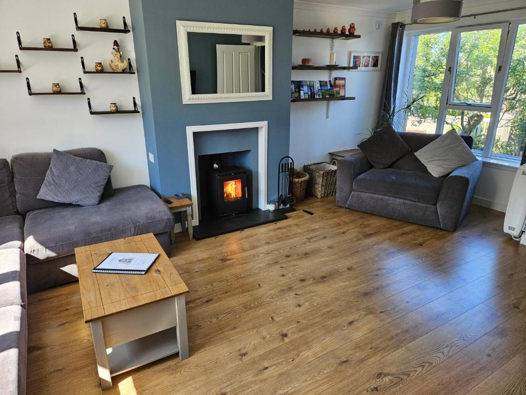 a living room with a couch and a fireplace at Mansefield in Lerwick