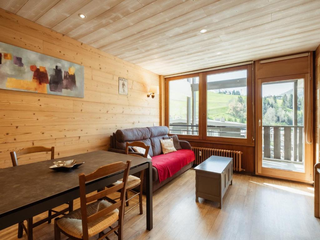 a living room with a couch and a table at Appartement La Clusaz, 3 pièces, 6 personnes - FR-1-304-77 in La Clusaz
