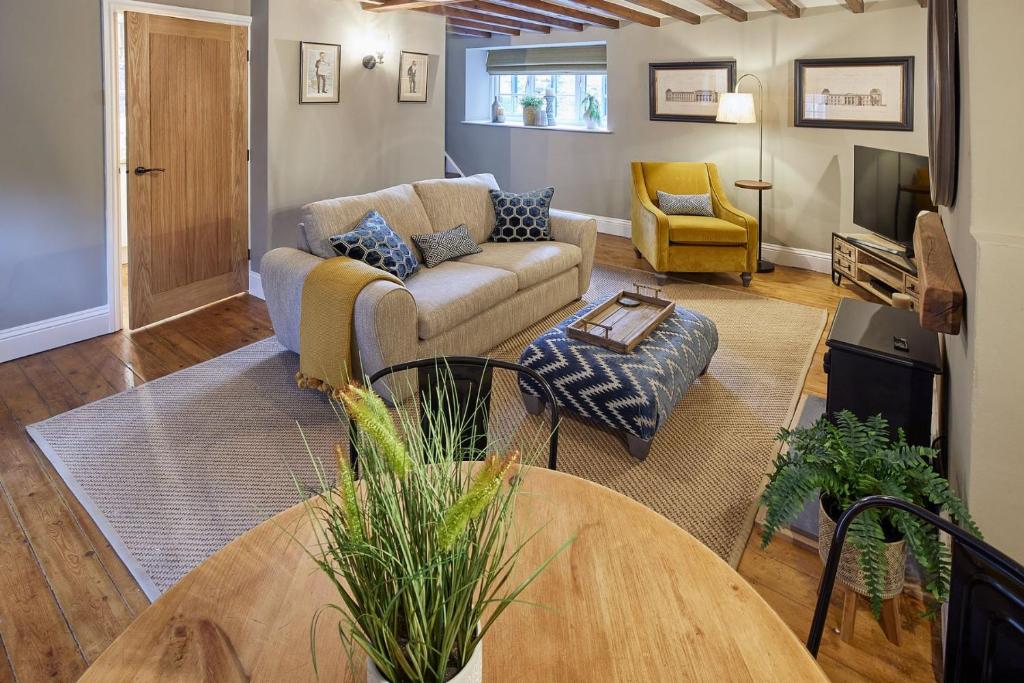 a living room with a couch and a table at Nook Cottage in Richmond