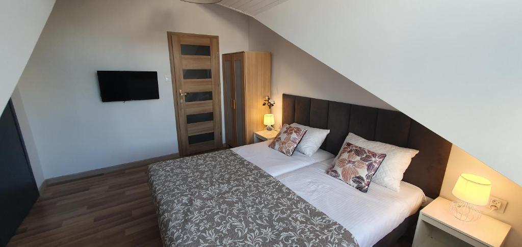 a bedroom with a large bed with two pillows at Villa 31 in Sopot