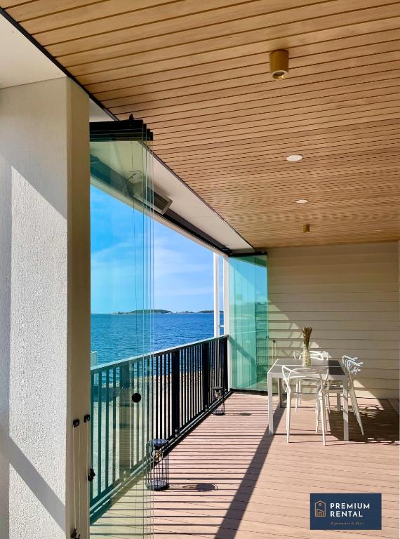 a balcony with a table and a view of the ocean at A13 Premium Double room II floor in Hanko