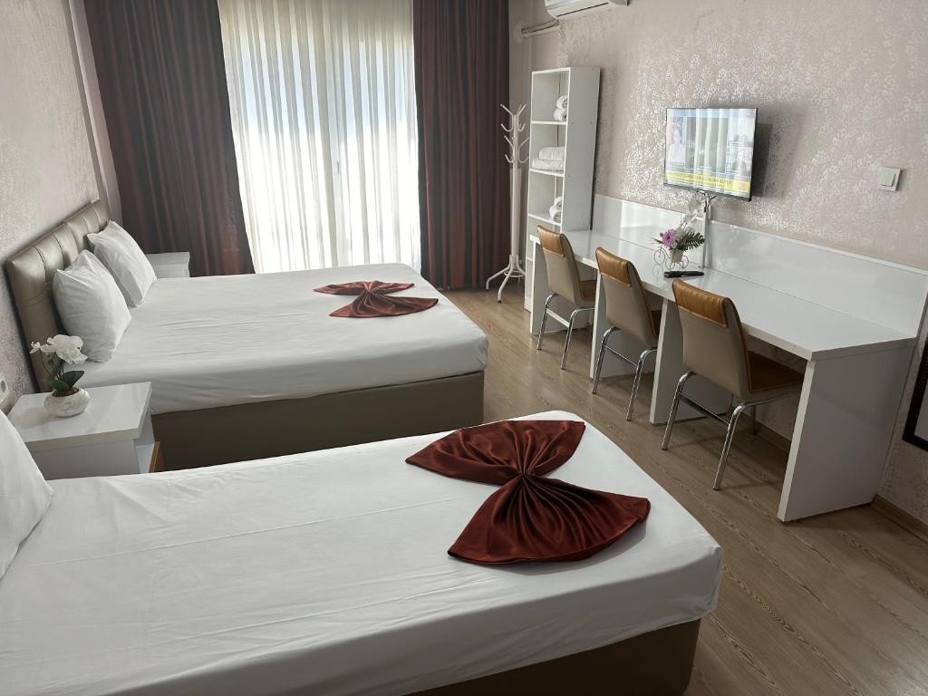 Łóżko lub łóżka w pokoju w obiekcie Park ULUSOY Hotel
