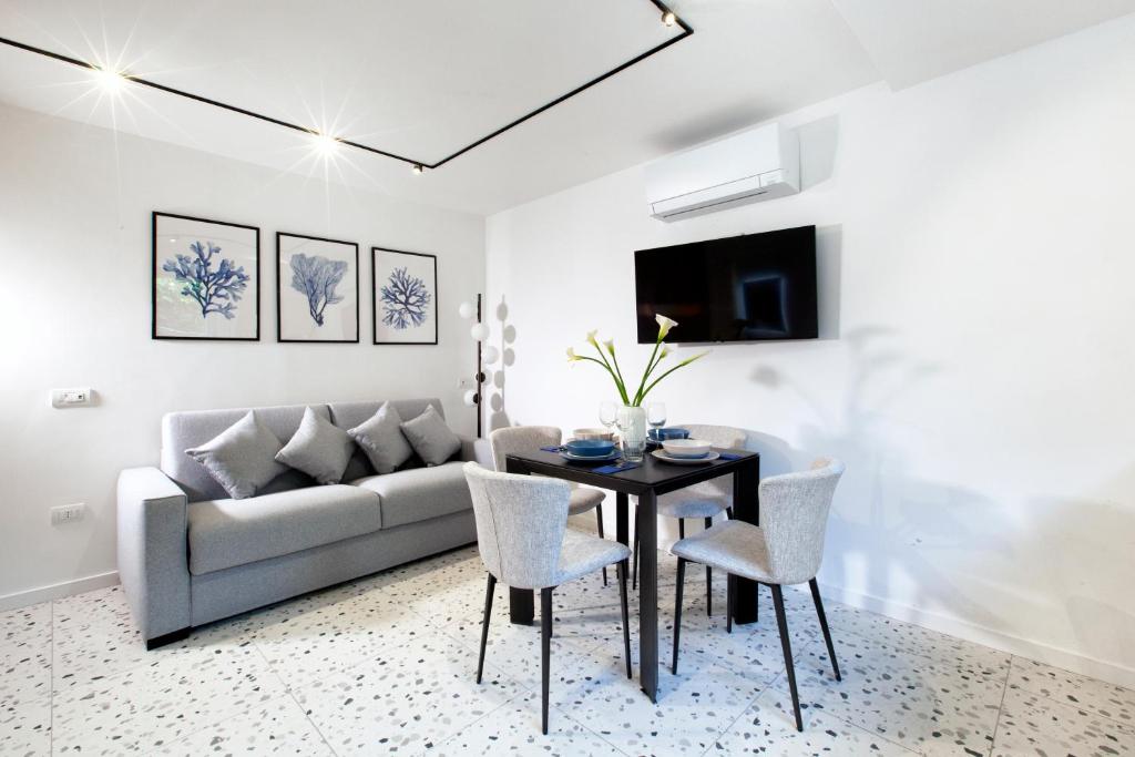 a living room with a couch and a table and chairs at Capri House in Capri