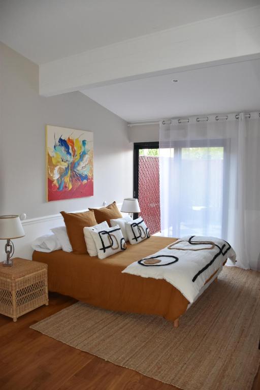 a bedroom with a large bed and a window at LES CHAMBRES DE MARIE in Bordeaux