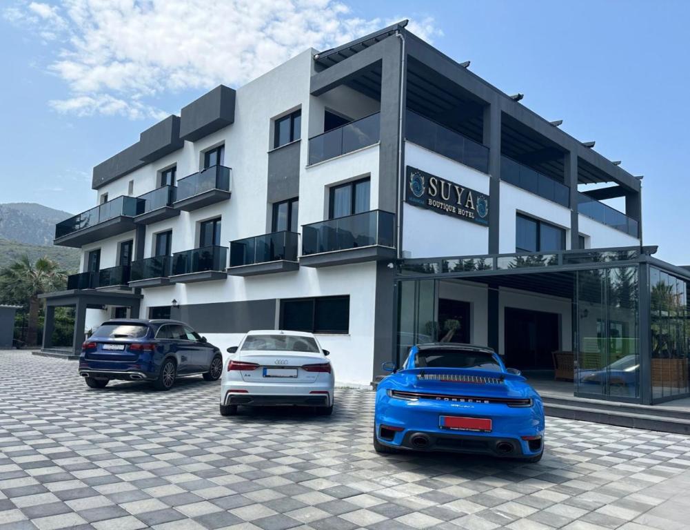 a building with three cars parked in front of it at Suya Boutique in Kyrenia