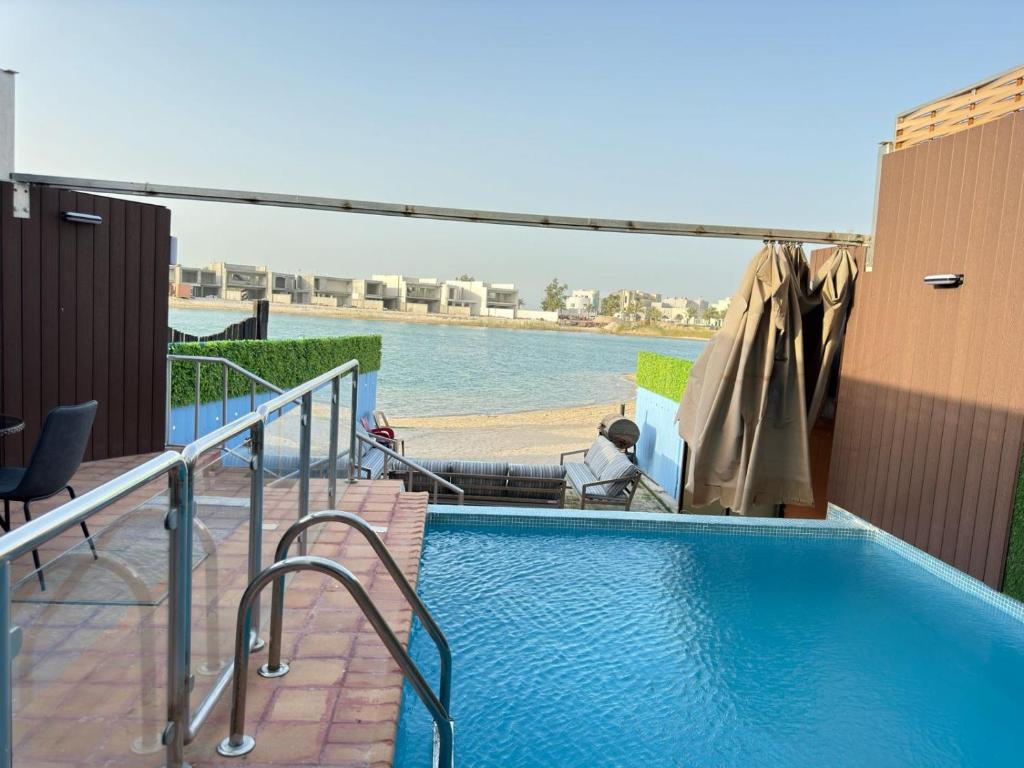 a swimming pool on the side of a building at سافانا امواج Amwaj savana in Half Moon Bay