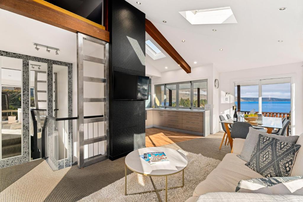 a living room with a couch and a table at Central Style - 3 Bedroom Townhouse with Lakeview in Queenstown