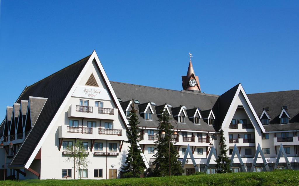 a large white building with a clock tower in the background at Coppid Beech in Bracknell