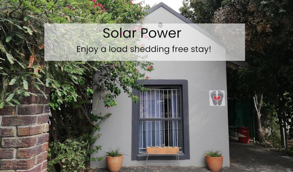 a sign that reads solar power enjoy a load shedding treestay at Feet Up Cottage in Somerset West