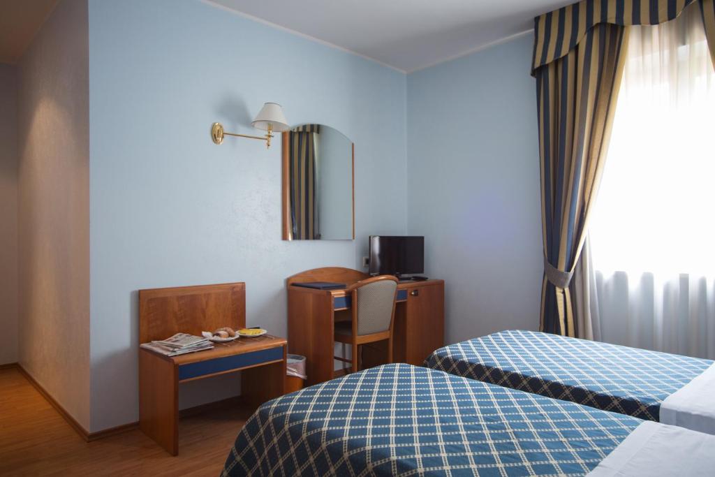 a hotel room with a bed and a table and a desk at Hotel Levante in Fossacesia