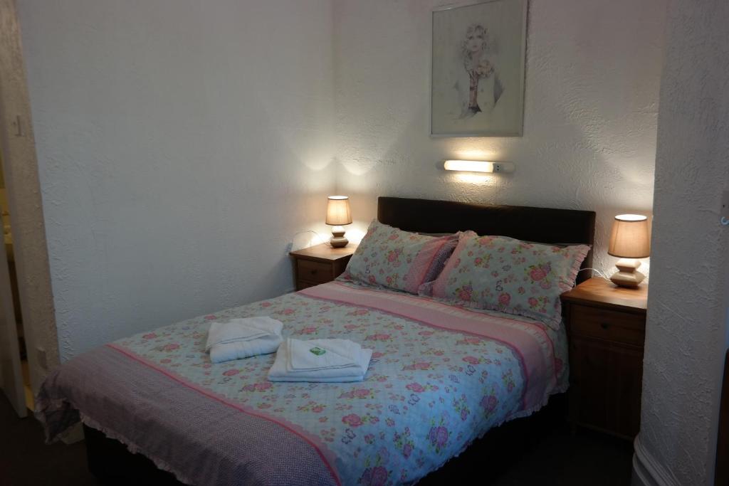 a bedroom with a bed with two towels on it at Cardoh Lodge in Blackpool