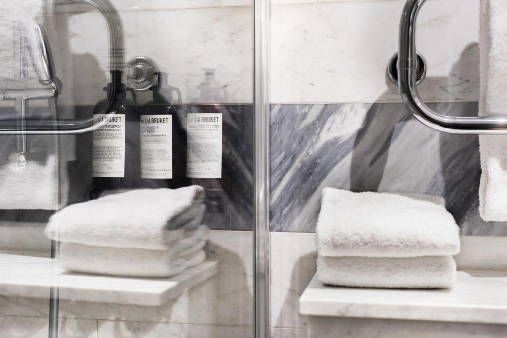 a pile of towels on display in a bathroom at Hotel Hasselbacken in Stockholm