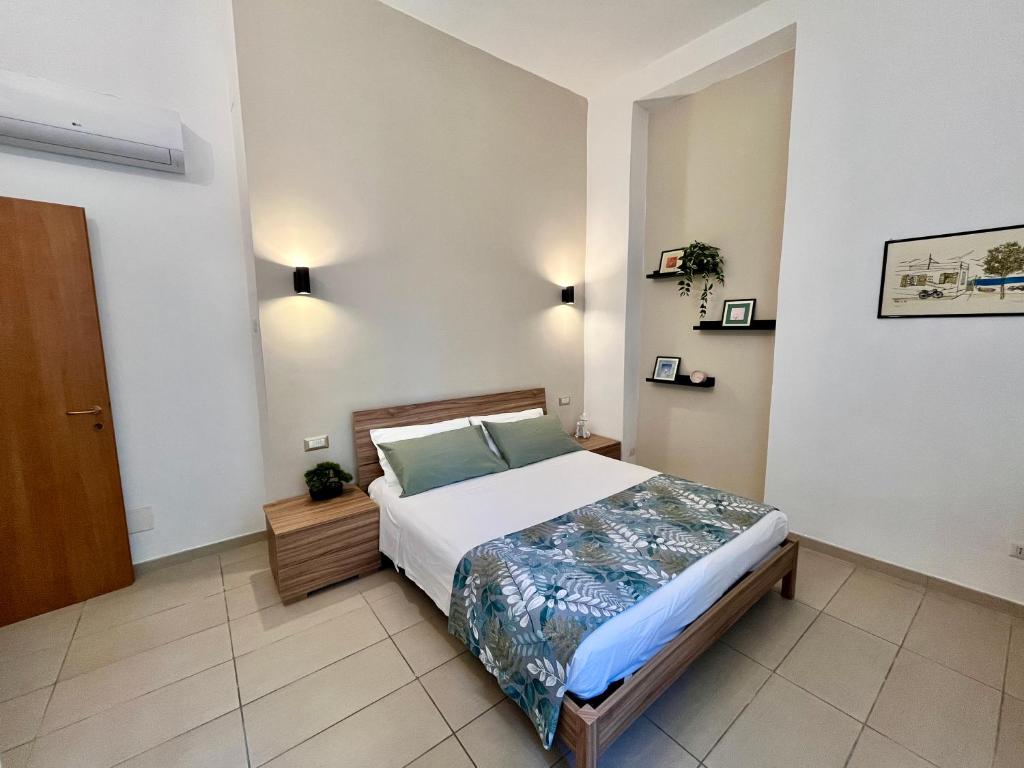 a bedroom with a large bed in a room at DMC Residence - Alloggi Turistici in Anzio