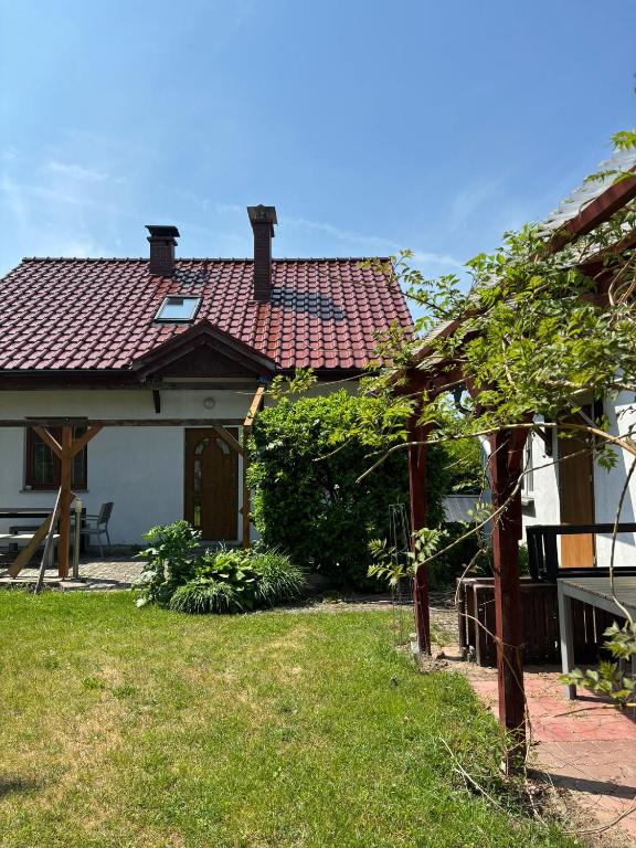 a house with a gazebo in the yard at Apartament u Zosi in Wisełka