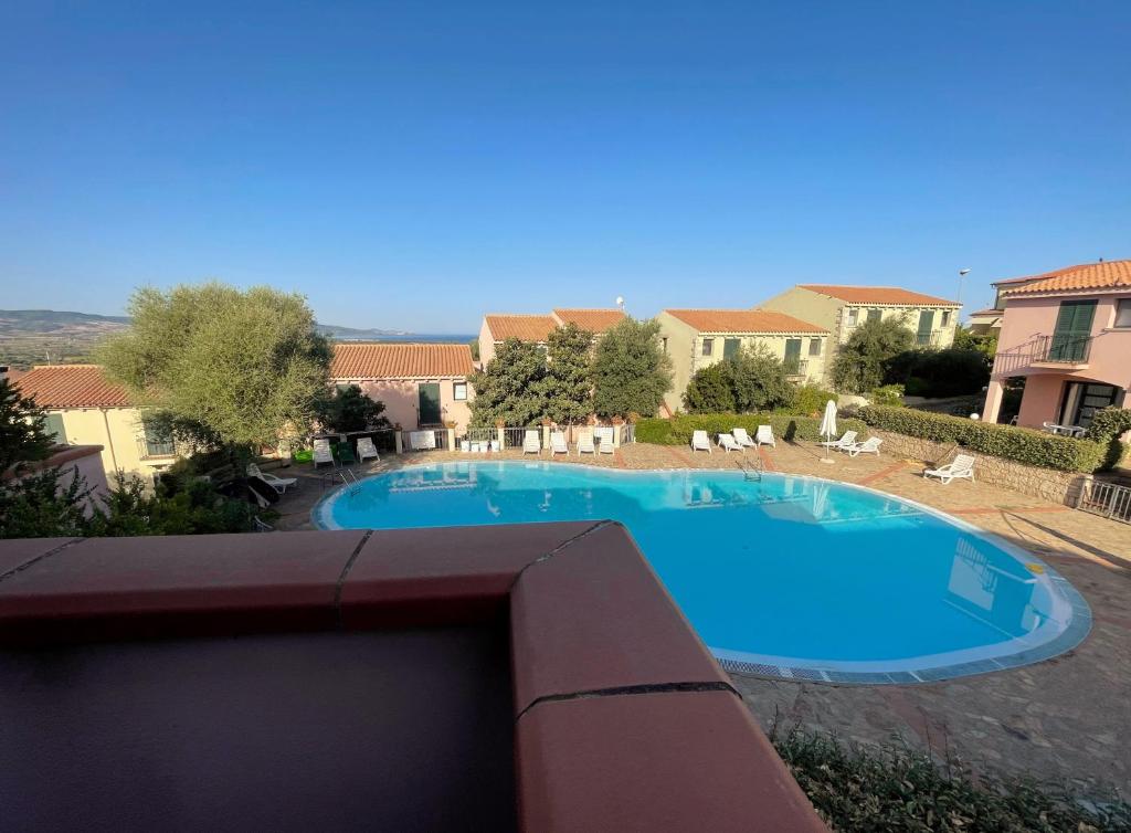 a view of a swimming pool from a balcony at Gallura da Cino in Badesi