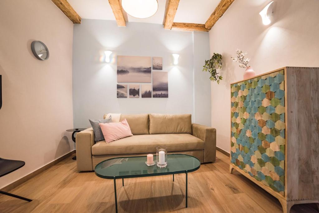 a living room with a couch and a table at Casa Verde - Brasov Homes in Braşov