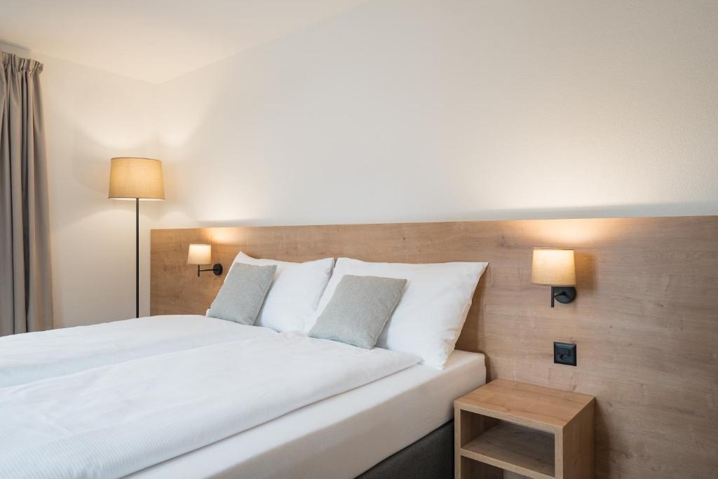 Postel nebo postele na pokoji v ubytování Hotel Brocco & Posta