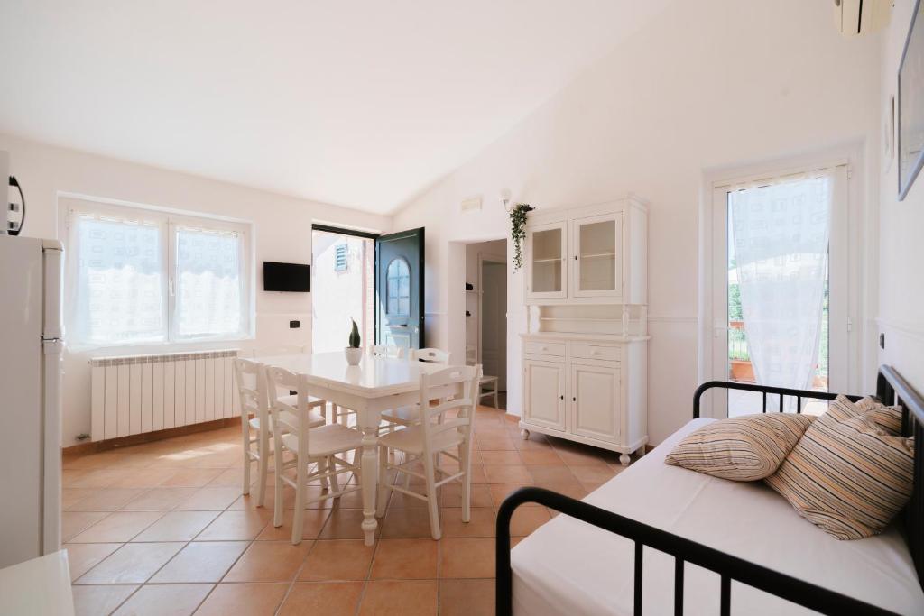 a kitchen and dining room with a table and chairs at Villa Chiara Porto Recanati in Porto Recanati