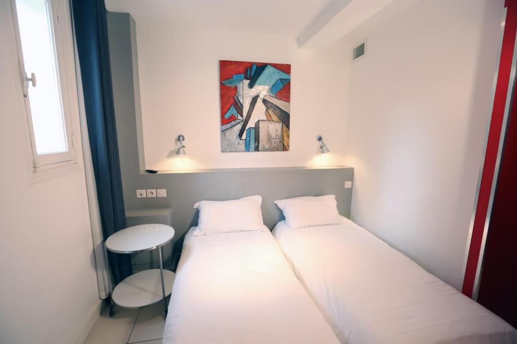 Postel nebo postele na pokoji v ubytování Hôtel de la Plage - HDLP