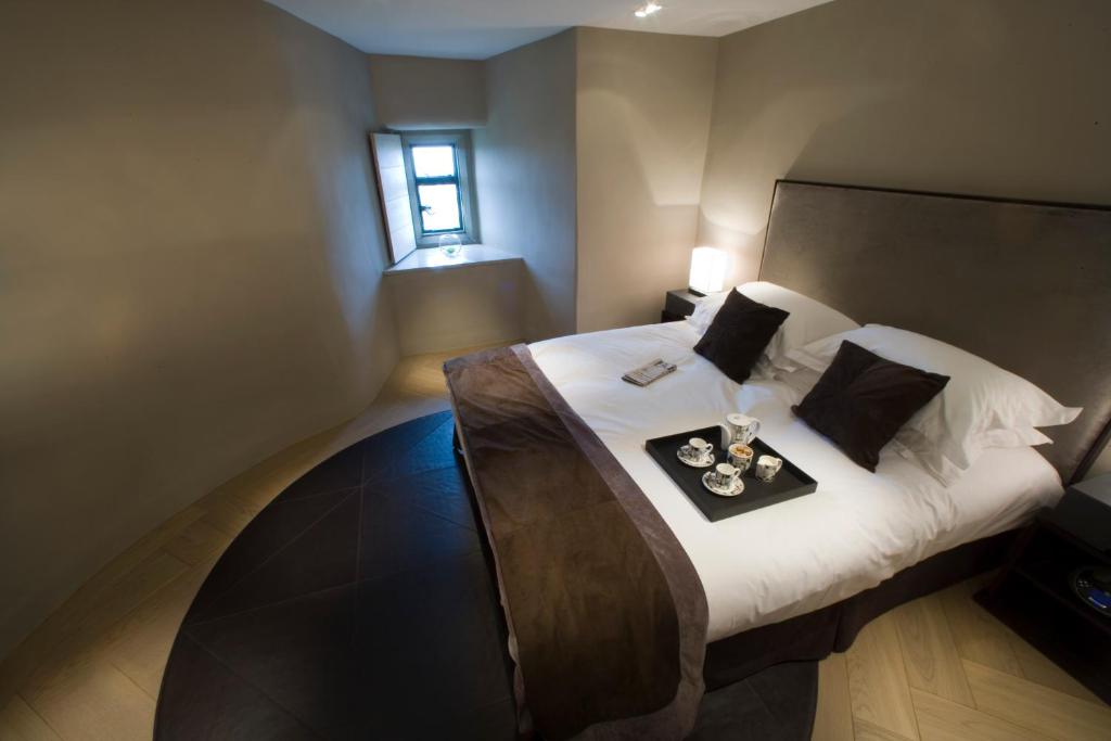 a bedroom with a bed with a tray of food on it at Roch Castle in Roch