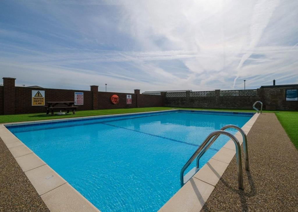 a large blue swimming pool with a metal hand rail at Cockerham Sands in Cockerham