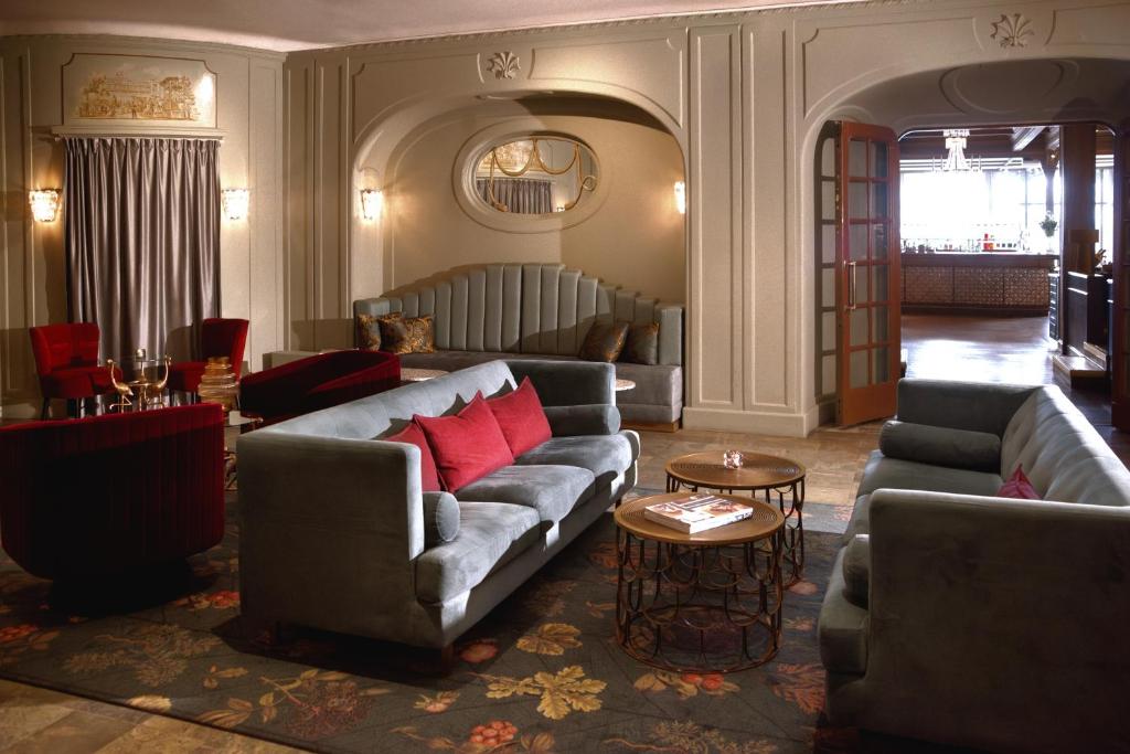 a living room with two couches and a table at Hotel Hasselbacken in Stockholm