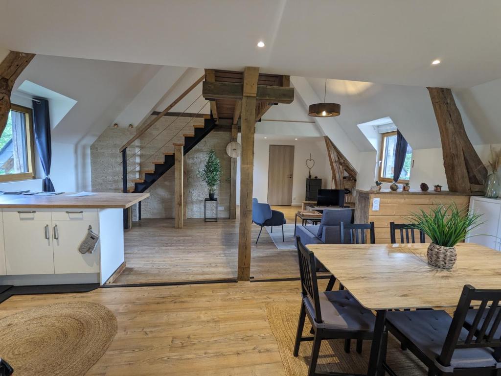 une cuisine et un salon avec une table et des chaises dans l'établissement Appartement au calme entre Terre et Mer. Proche Honfleur (5min) Deauville (15min), à Barneville-la-Bertrand