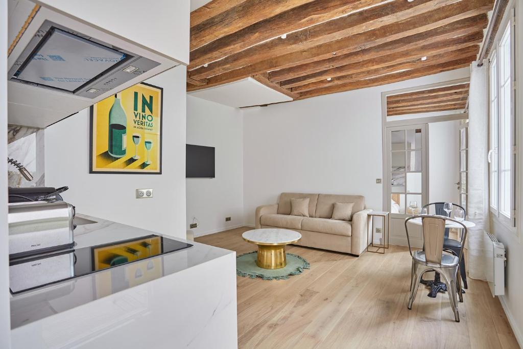 a living room with a table and a couch at Eiffel Tower Apartment/Invalide by Studioprestige in Paris
