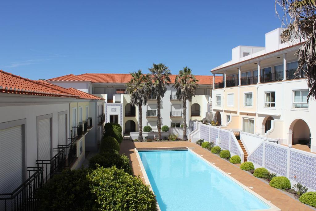 an apartment with a swimming pool in a building at Confortavel T2 in Óbidos
