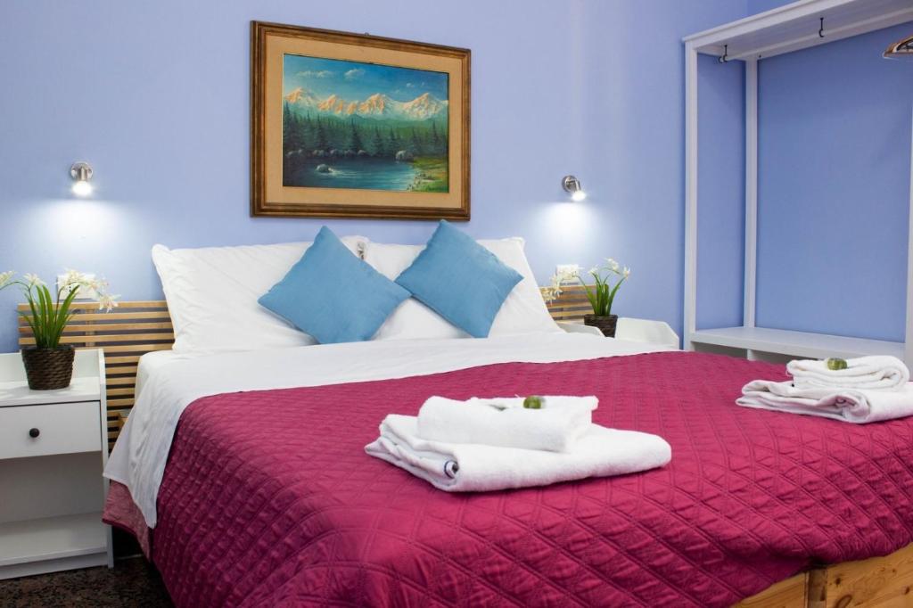 a bedroom with a large bed with towels on it at B&B Corso Italia in Pisa