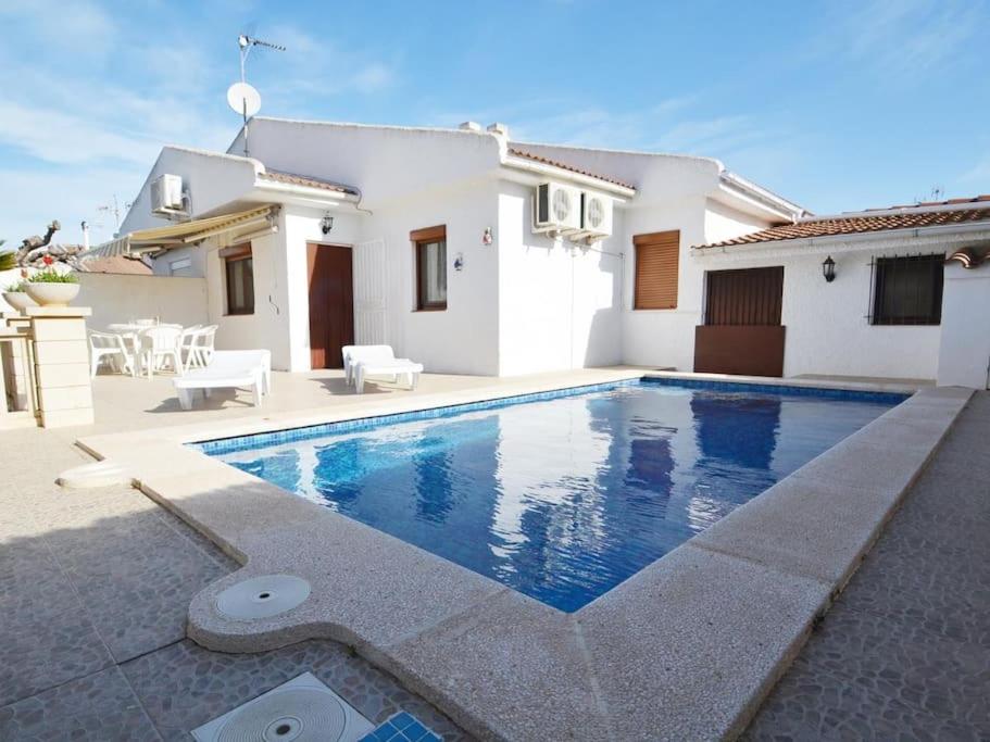 a villa with a swimming pool in front of a house at Camins 2 in Riumar