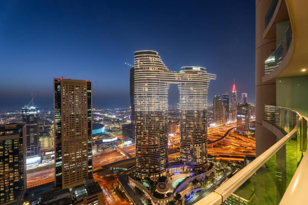 Hotel Luxe 2BR Burj Vista Retreat, Steps from Dubai Mall & Burj Khalifa, a view of a city skyline at night at Luxe 2BR Burj Vista Retreat, Steps from Dubai Mall & Burj Khalifa in Dubai