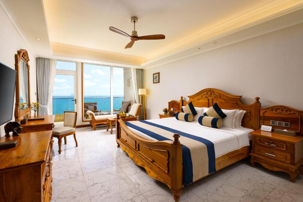 a bedroom with a bed with a view of the ocean at Araliya Beach Resort & Spa Unawatuna- Where you meet the sea all year in Unawatuna